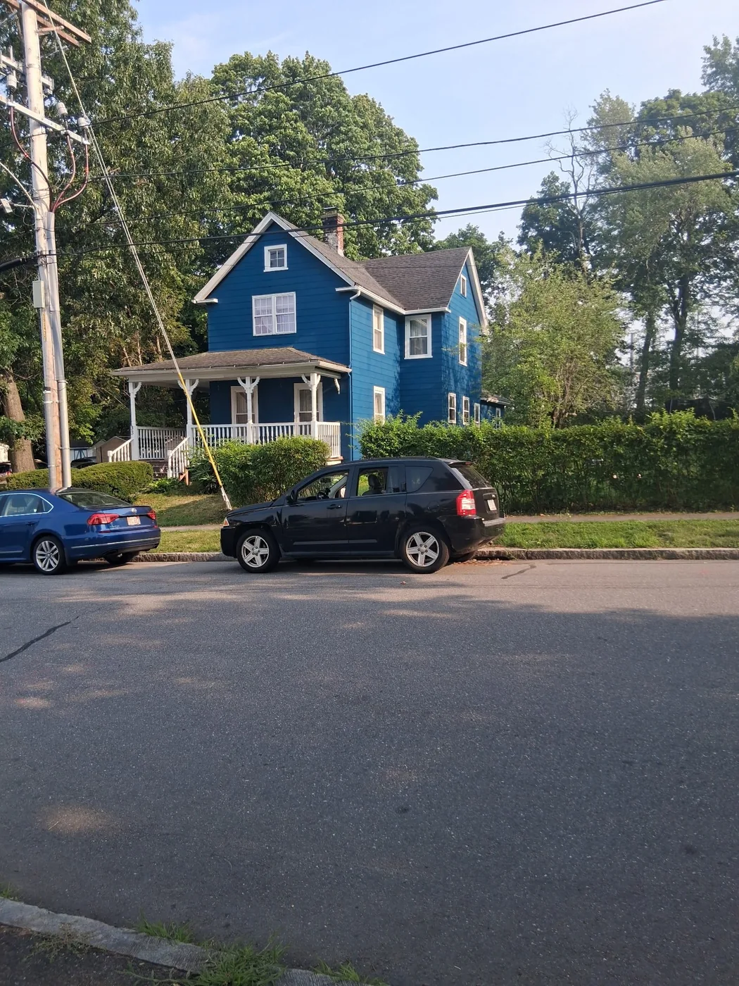 Blue painted house with white trim after exterior work