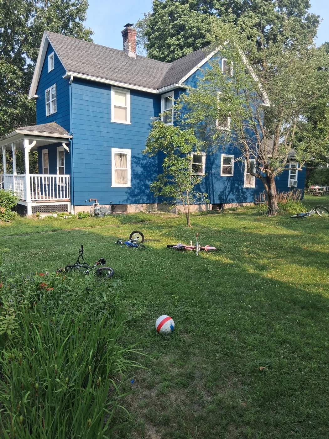 Bright blue painted home from the side yard