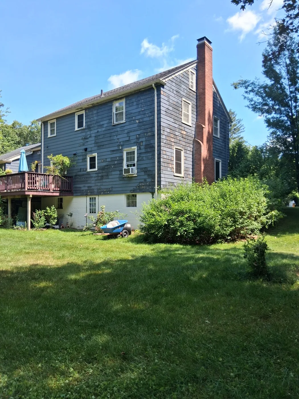 Weathered blue exterior before restoration work