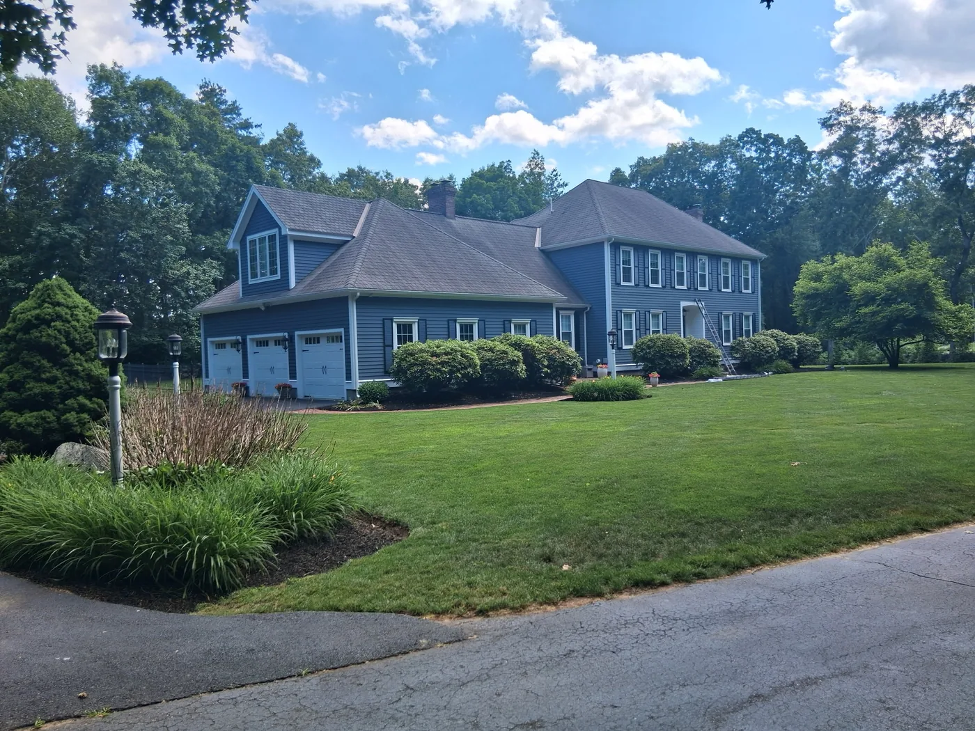 Large painted home with gray-blue exterior and white trim