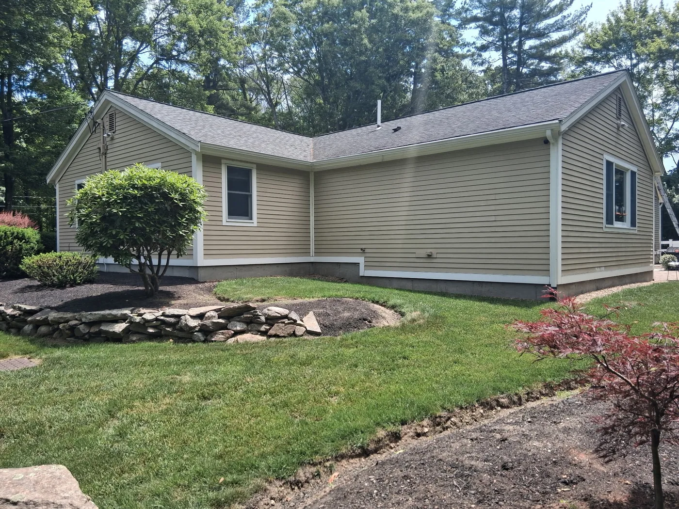 Freshly painted tan home with white trim