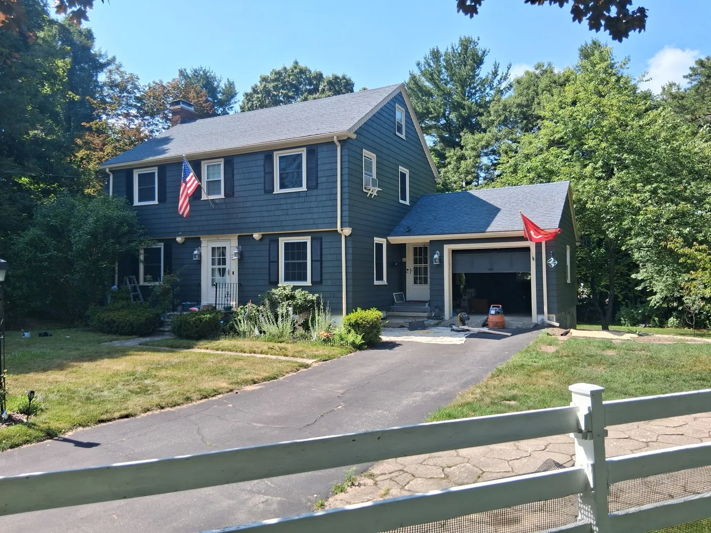 Dark painted two-story home with white trim