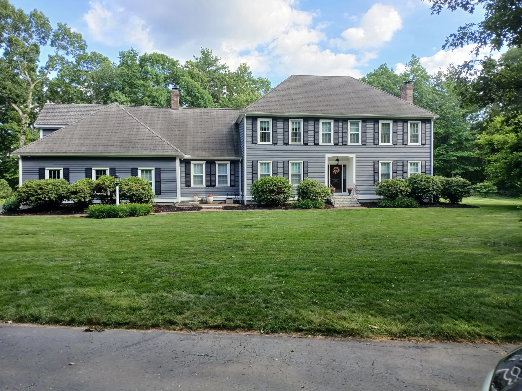 Recently painted large Massachusetts home with dark gray exterior and white trim