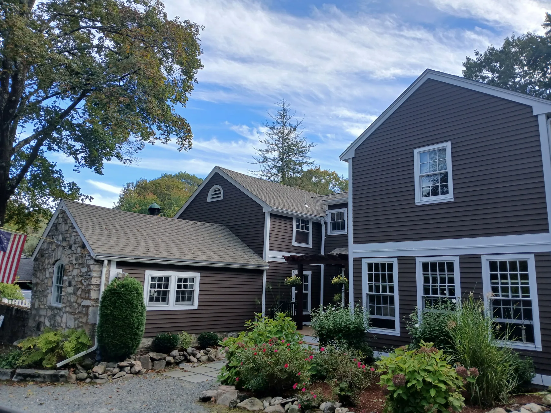 Dark brown painted home with crisp white trim